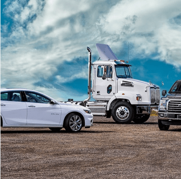 Fleet vehicles parked against blue sky