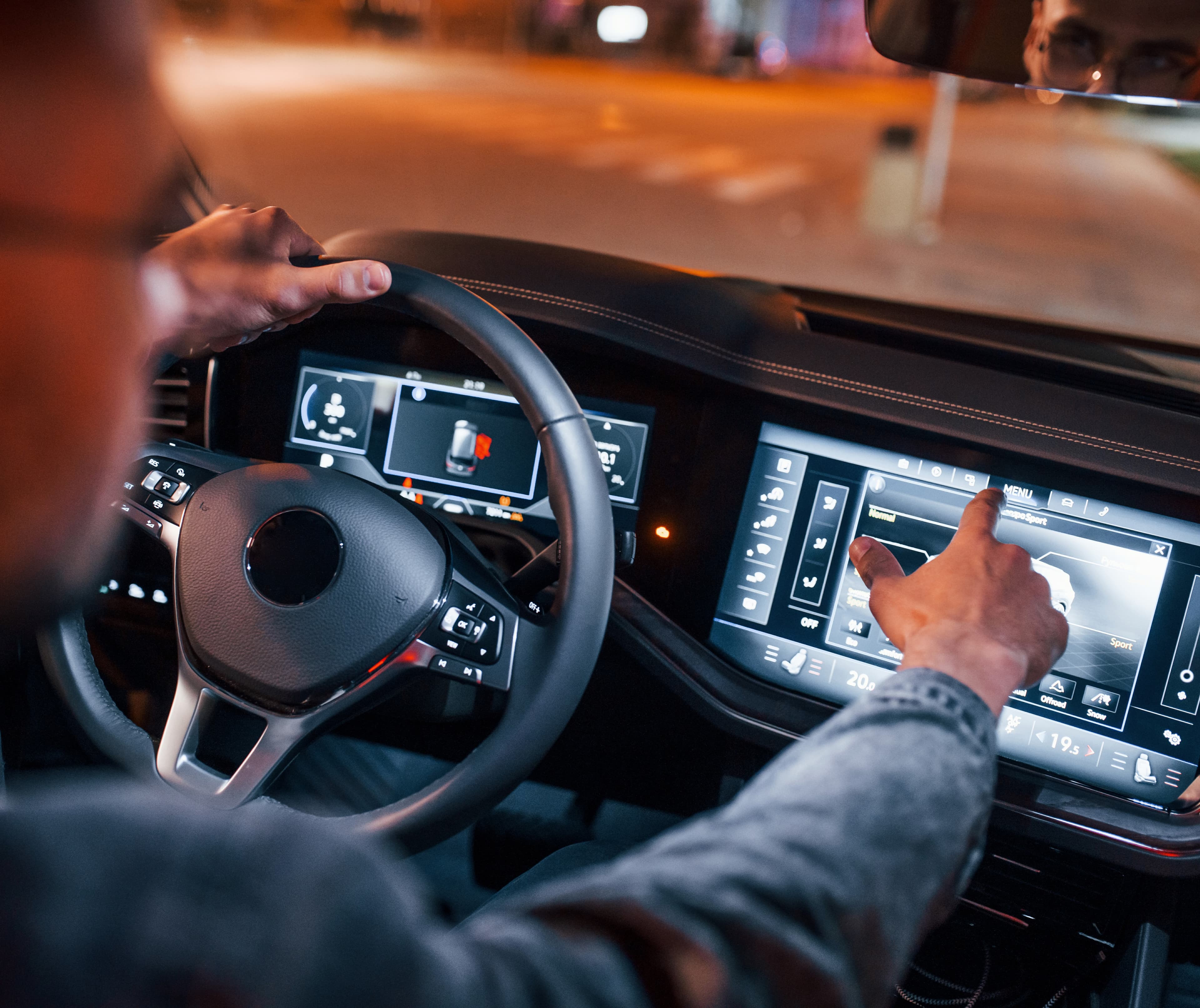 A professional driver uses a vehicle touchscreen to review navigation or driving data, illustrating how data and technology support fleet safety and informed driving decisions. A professional driver uses a vehicle touchscreen to review navigation or driving data, illustrating how data and technology support fleet safety and informed driving decisions.